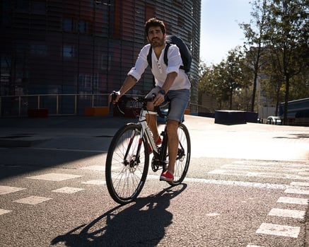 Man with backpack riding a bicycle