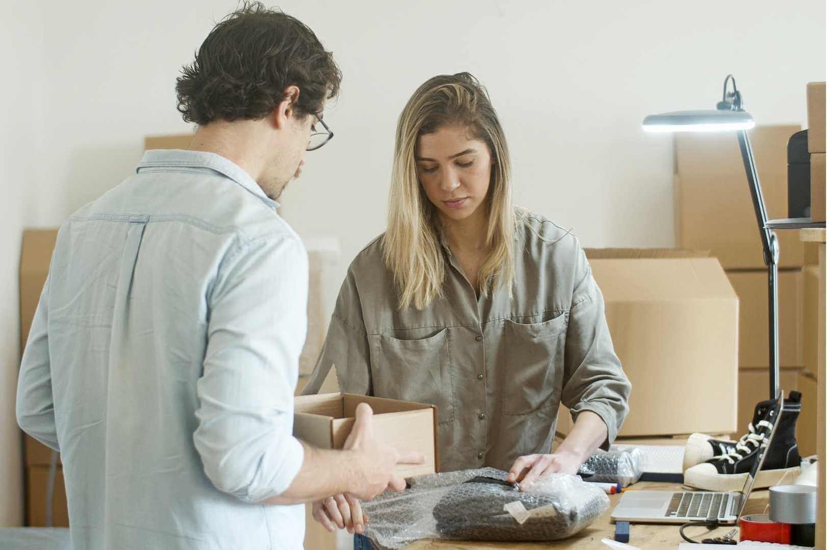 man helping woman with packaging
