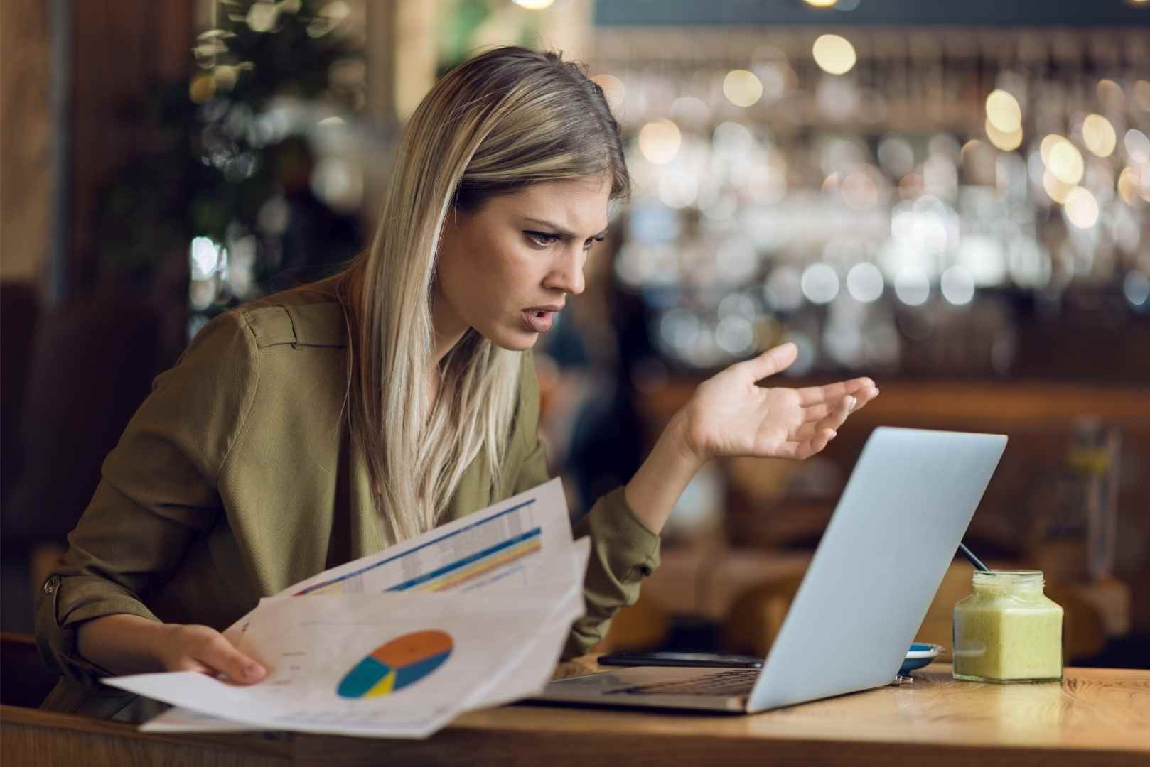 worried businesswoman reading on laptop